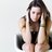 Portrait of depressed young woman sitting at home.