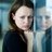 Young woman leaning against glass wall in crisis moment.