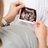Pregnant woman looking at ultrasound abdominal scan photo of developing fetus.
